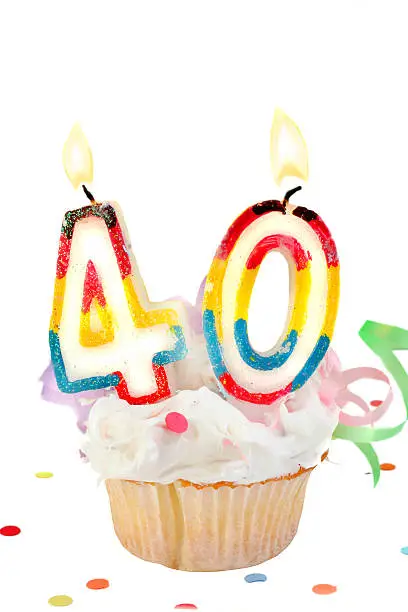 fortieth birthday cupcake with white frosting on a white background