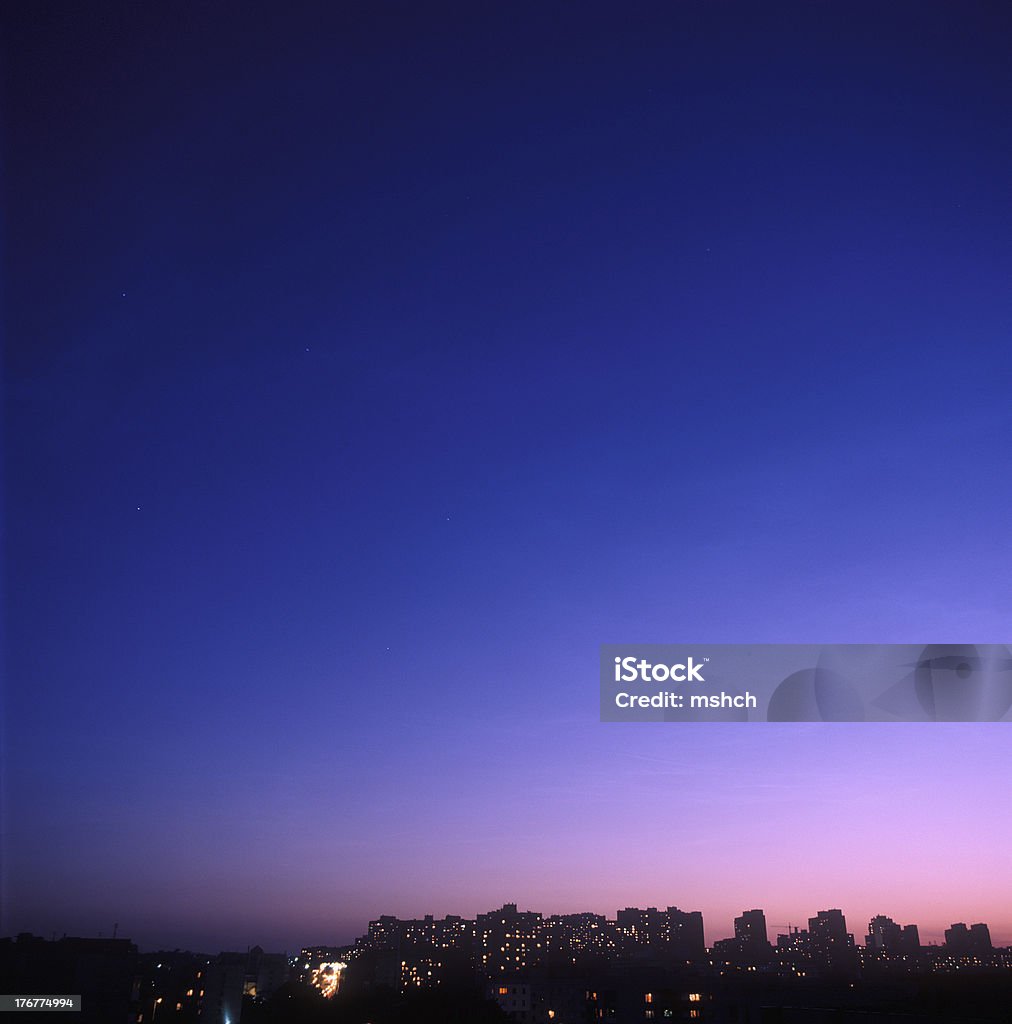 Twilight over a city. Twilight over a city with houses silhouettes against the sky. You can find my other similar photos Architecture Stock Photo