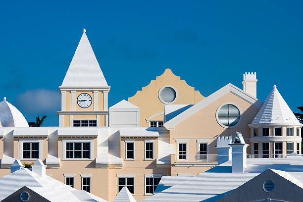 The tops of beige condominiums in Bermuda Bermudian architecture along the waterfront of Hamilton, Bermuda. bermuda roof stock pictures, royalty-free photos & images