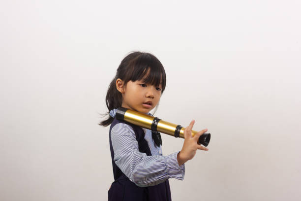 istock little girl with binoculars on white background 1767762816