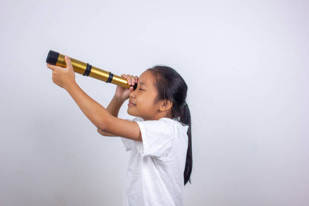istock little girl with binoculars on white background 1767763321