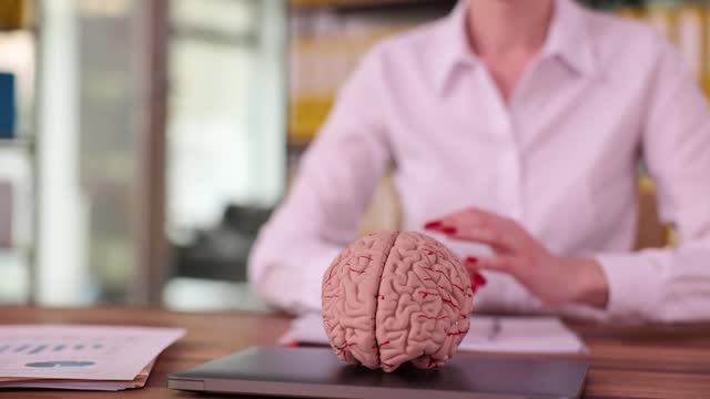 Woman putting human brain on laptop closeup 4k movie slow motion