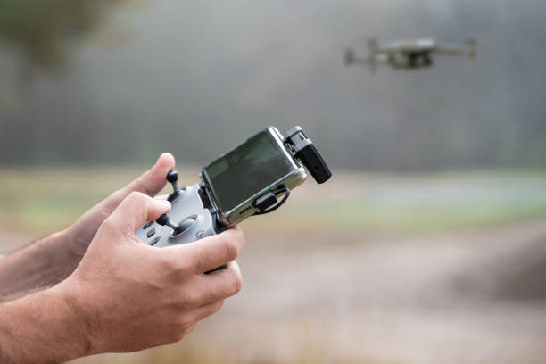 istock Photograph of man's hands holding the remote control of a Drone, Drone Operator . Technology concept. man is having fun with quadcopter in nature. control panel of the UAV in male hands is close-up. 1767768959