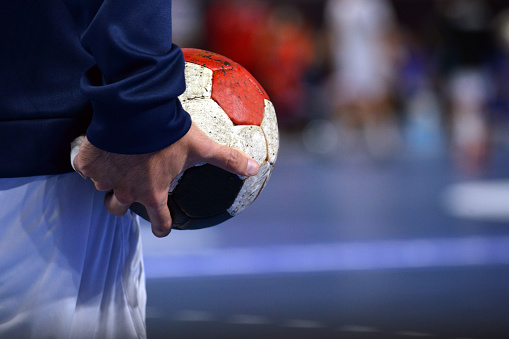 Handball Player warming up while holding a handball