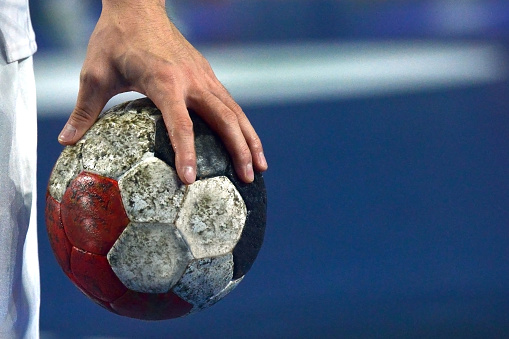 Handball Player warming up while holding a handball