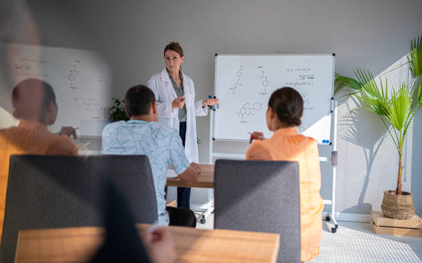istock Female teacher teaching nontraditional students at university. Back to school. Pharmacy class. 1767771216