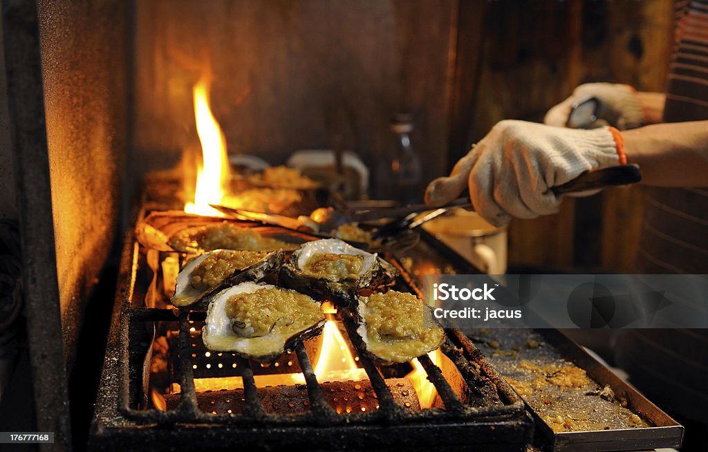 Cooking in outdoor kitchen "Cooking oysters in outdoor Chinese restaurant, by night." Accessibility Stock Photo
