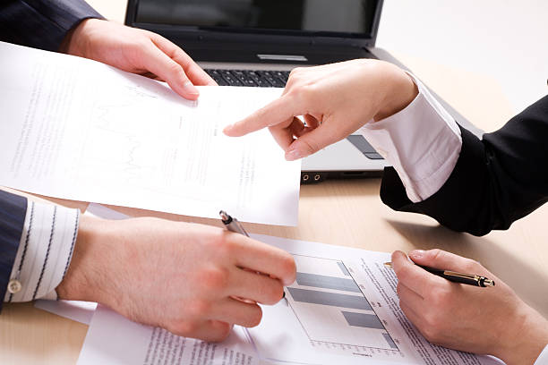 istock Close up of paperwork shared between two people 176777804