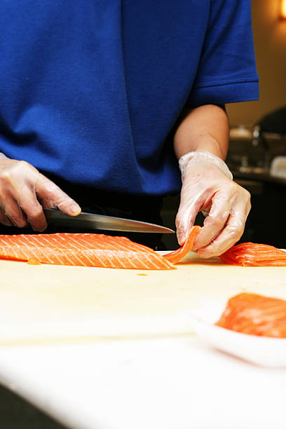 istock Young Person Cutting Fish for Sushi 176779188