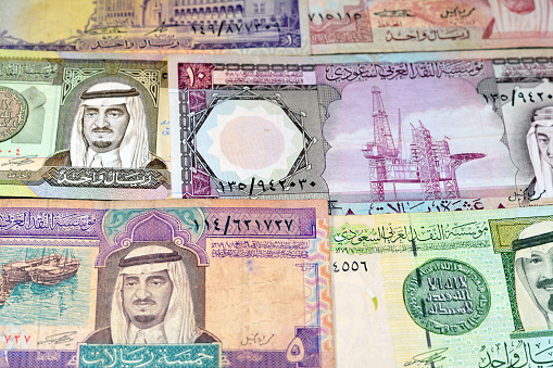 Old Saudi Arabia riyals money banknote bills of different eras from the kingdom of Saudi Arabia times, vintage retro old Saudi currency, value, exchange rate of the currency, old notes, selective focus