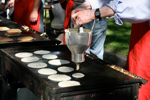 Stampede Pancake breakfast - stock photo of people making pancakes for the crowd.
