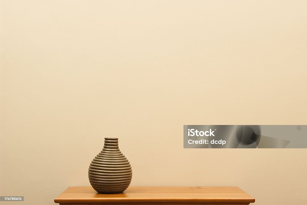 Short striped vase on small table Short striped vase still life - horizontal Arrangement Stock Photo