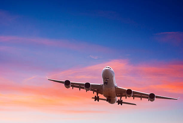 istock Jet Aeroplane Landing from Bright Blue Red Sunset Sky 176780924