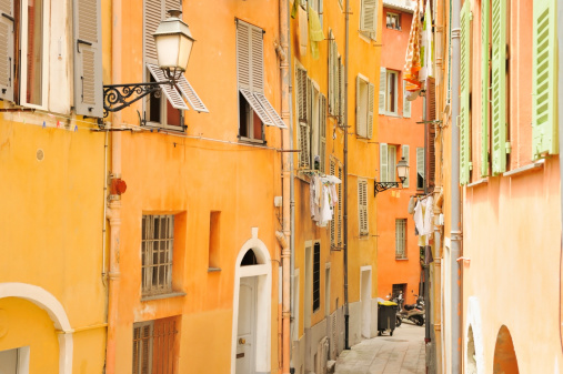 Narrow alley in the old part of Nice - city, on the coast of the Mediterranean sea,