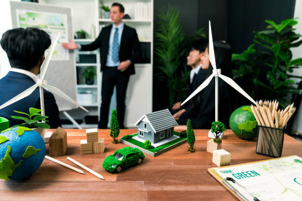 istock EV car model with mockup wind turbine on blurred background meeting. Quaint 1767849395