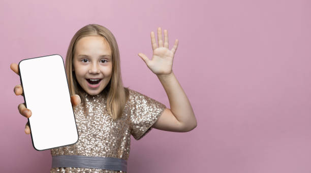 istock Young child girl holding smartphone with blank empty white screen display 1767849957