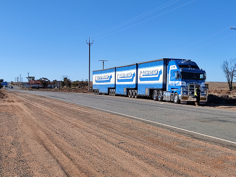 Road train along the Barrier highway in Cockburn, a town at the border between South Australia and New South Wales.