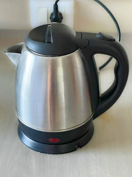 istock Stainless steel kettle on a smooth timber table in a hotel room 1767855527
