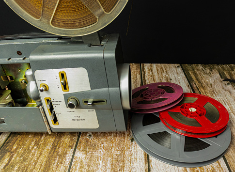 old movie projector and reel of tapes