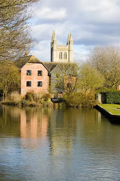 "A view along the River Kennet towards the town of Newbury, Berkshire.  The church is that of Saint Nicholas."