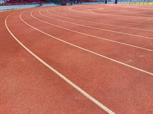 istock The ground running track is brick red with white lines 1767885774