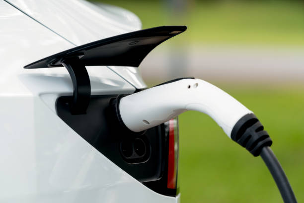istock Closeup EV plug charger attached to EV car for battery recharging. Exalt 1767895534