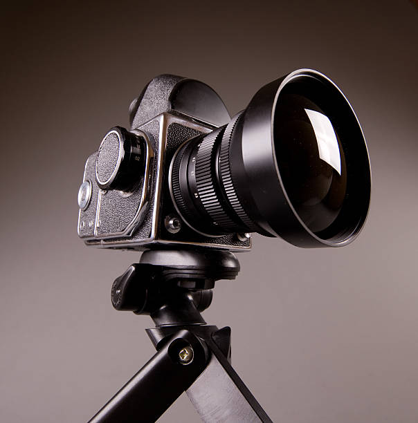 istock Old photo camera with tripod on grey in Hi-Res 176789878