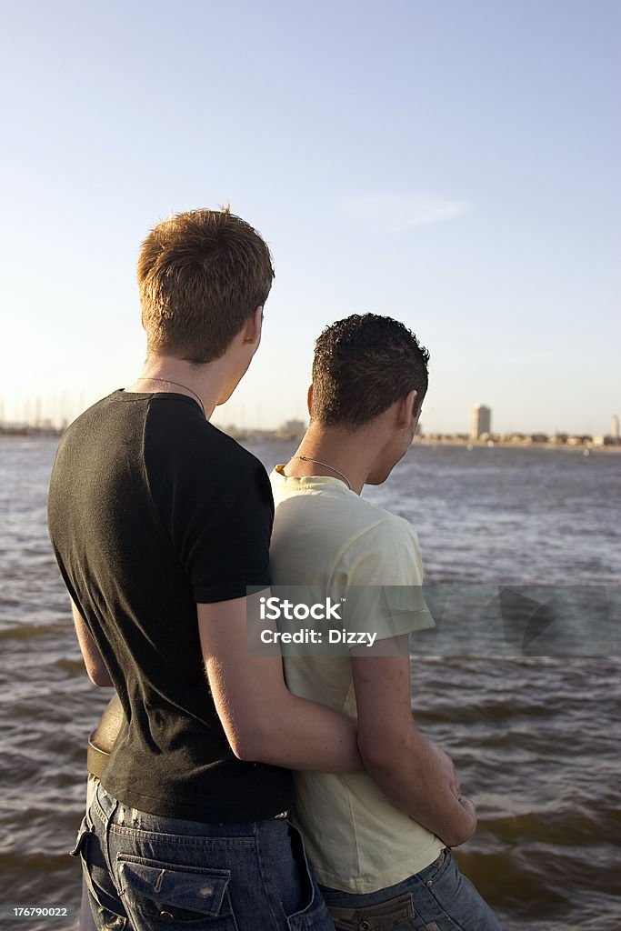 Gay couple: close Close gay couple looking out at the ocean. Beach Stock Photo