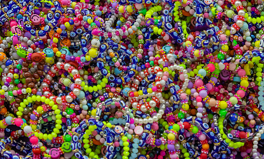 Pile of colorful pearls bracelets jewelry pattern background