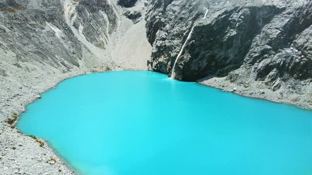 Laguna 69 beautiful vivid blue lagoon in the Andean Mountains in Huaraz Peru tourism beyond Machu Picchu
