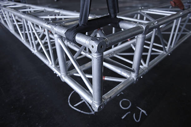 Silver metal rigging truss on a black floor Truss for speakers and light - shallow depth of field - Adobe RGB sailboat mast stock pictures, royalty-free photos & images