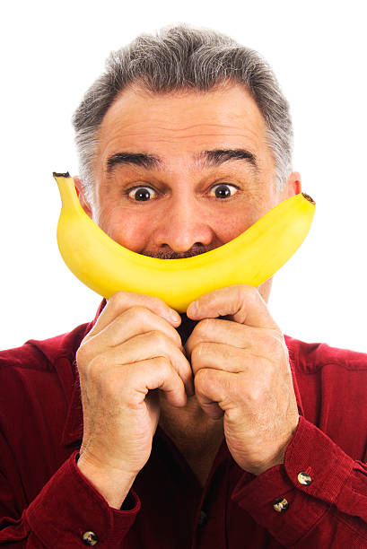 istock Man hold banana to face, imitating smile 176792536