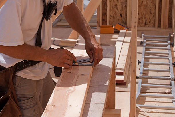 istock Carpenter measuring a wood 2x4 with triangle ruler and pencil 176792815