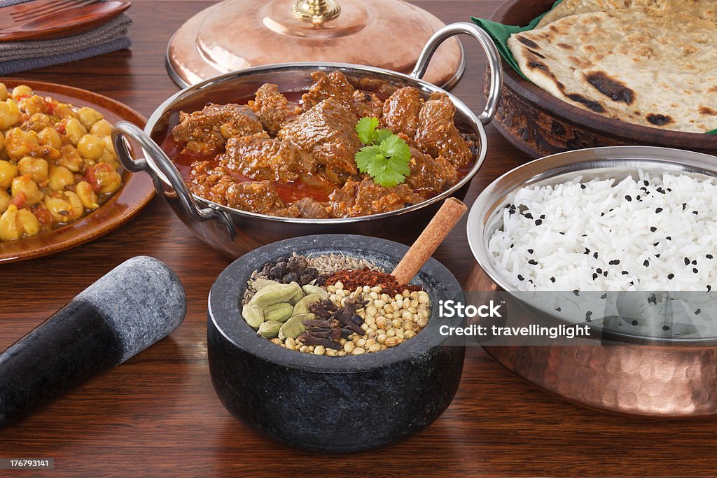 Indian Food Lamb Rogan Josh Curry Spice Selection "A selection of Indian food and spices, lamb rogan josh, chana masala, spices, basmati rice and parathas. The spices shown are the ones  used in the lamb curry. For MANY MANY MORE CURRIES please click" Basmati Rice Stock Photo