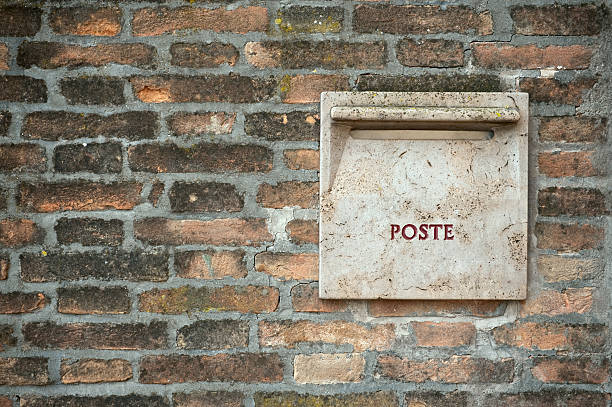 istock Old italian stone postbox in brick wall 176793606