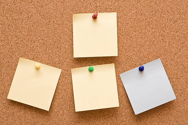 Note papers pinned to corkboard stock photo