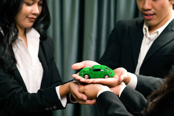 istock Business people synergy holding EV car model. Quaint 1767946230