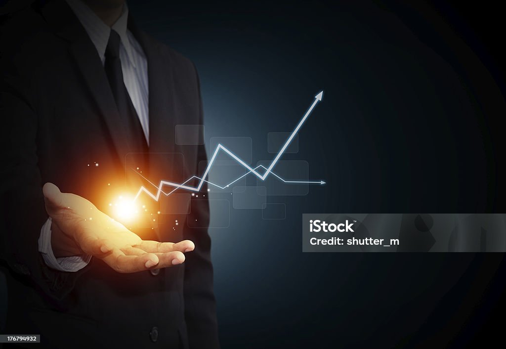 Hand holding a rising arrow Hand holding a rising arrow, representing business growth. Making Money Stock Photo