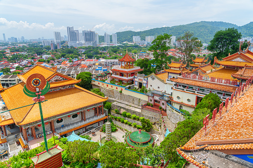 Penang, Malaysia - 30 April, 2023: View of the Kek Lok Si Temple in Air Itam. The largest Buddhist temple in Malaysia is a popular tourist attraction of Asia. George Town is visible in background.