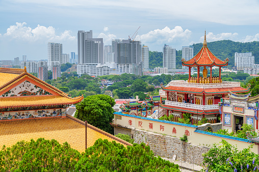 Penang, Malaysia - 30 April, 2023: View of the Kek Lok Si Temple in Air Itam. The largest Buddhist temple in Malaysia is a popular tourist attraction of Asia. George Town is visible in background.
