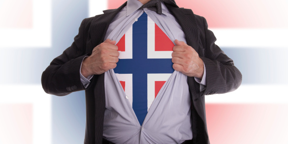 Business man rips open his shirt to show his Norwegian flag t-shirt