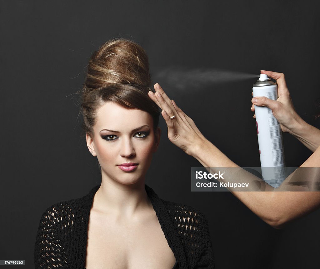 Young Woman Getting Hair Styled Studio shot Hairspray - Hair Product Stock Photo