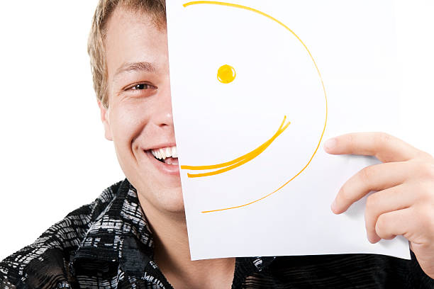 man with smiley on half of his face stock photo
