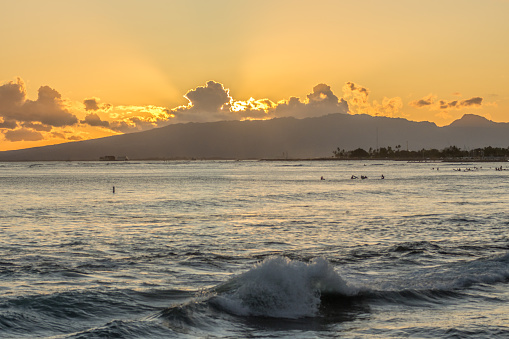 Sunset into the Pacific Ocean at Waikiki beach