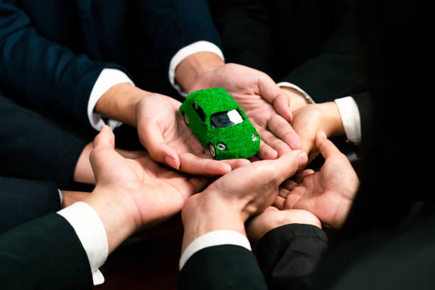 istock Business people synergy holding EV car model. Quaint 1767990976