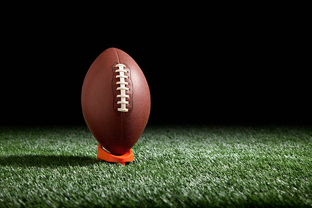 istock Football on a tee with dark background 176799283