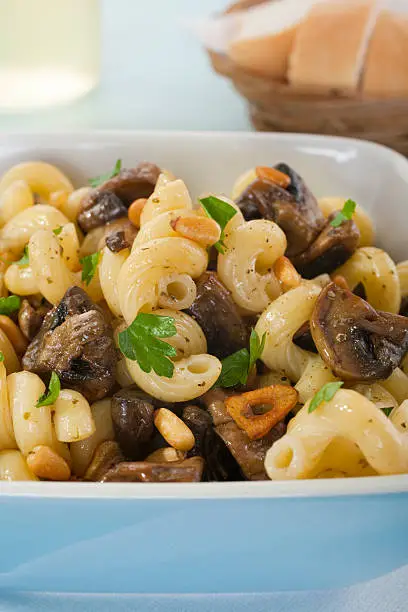"Delicious roasted mushrooms with garlic and pinenuts, swirled through riccioli pasta with Italian herbs. Healthy vegetarian food. More pasta-"