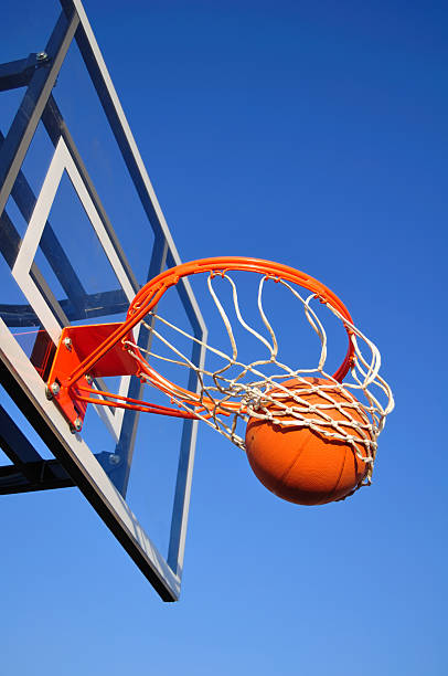 istock Basketball Shot Falling Through the Net, Blue Sky 176799874