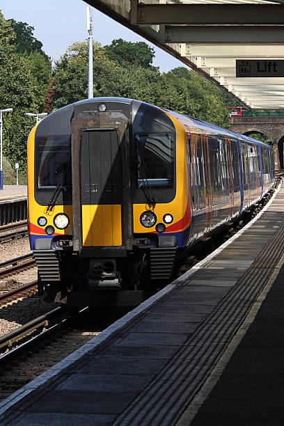 istock Electric passenger train arriving at station platform with commuters, UK 176800031