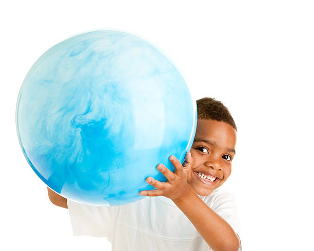 istock African American Little Boy Holding a Big Blue Ball 176801210